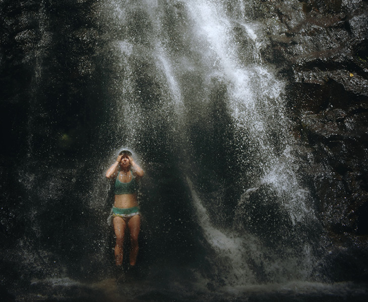 girl during shower under waterfalls outdoors