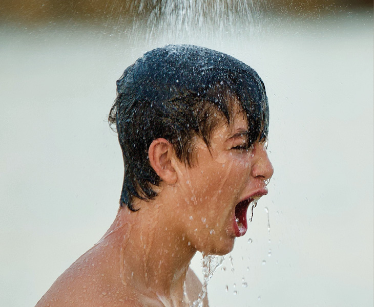 Boy takes cold shower thermal shock